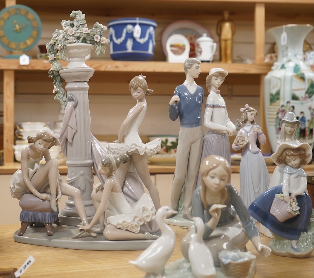 A large Lladro figure group of three ballet dancers by a tall floral column and eight other Lladro figures including a model of a bell. Tallest figure group 45cm high. Condition - golfer group, golf clubs broken.